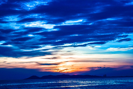 Sun sets over the seaの写真素材