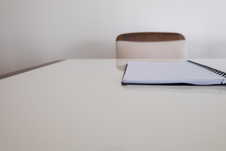 An empty chair with a notebookの写真素材