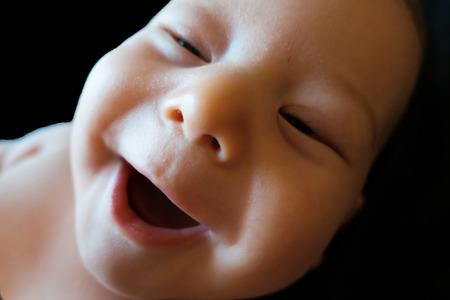 isolated innocent baby on a black background