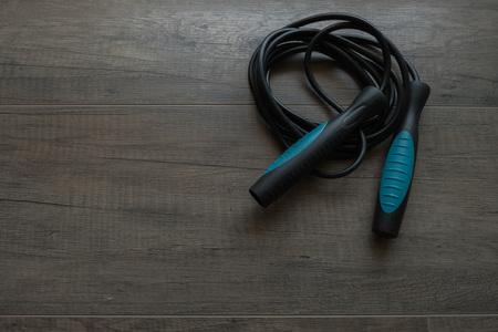 Blue jump rope on wooden backgroundの写真素材