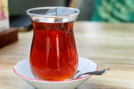 glass of Turkish tea, on wooden tableの写真素材
