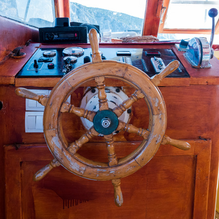 Ship's cabin with instruments and wooden wheel