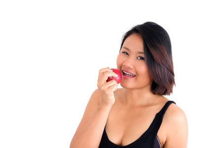 Woman on white background, smiling with an appleの写真素材
