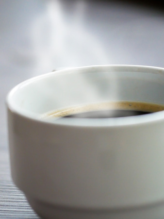 White coffee cup on table with smokeの写真素材