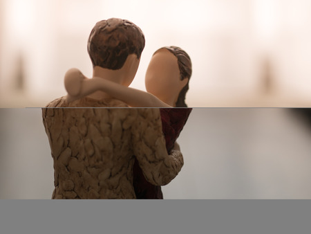 wooden dummy couple hug eachother love care,  bright tone with copy spaceの写真素材