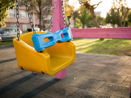 Colorful swing set at a playground in a parkの写真素材