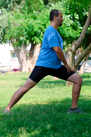 white man exercise and stretch in a park