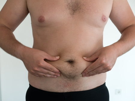 man with big belly on white background, fat conceptの写真素材