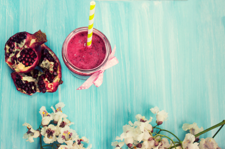 Pomegranate smoothie on blue backgroundの写真素材