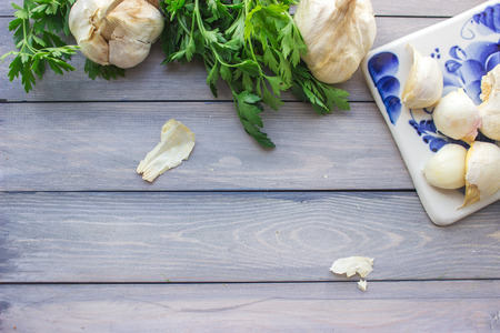 Garlic and parsley on cutting boardの写真素材