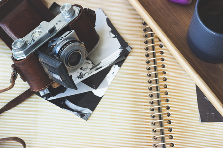 Old retro camera on aged photo album - abstract backgroundの写真素材
