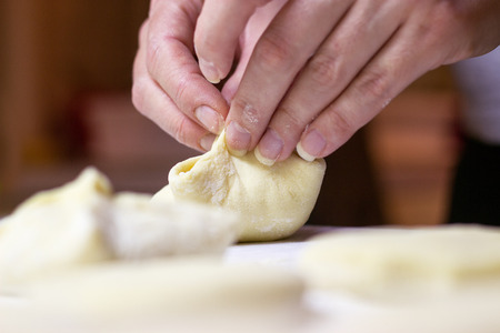 Beautiful woman hands making dough