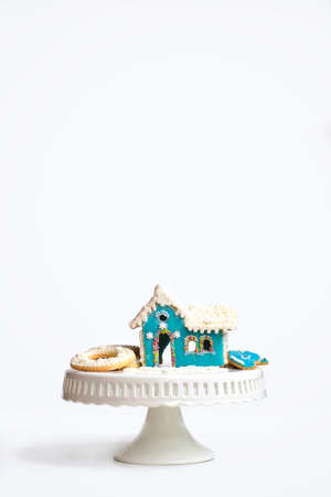 Homemade blue house gingerbread cookie, on white background with copy space; christmas/new year backgroundの写真素材