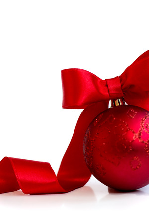 Red christmas ball, with red ribbon and bow, on white background with copy spaceの写真素材