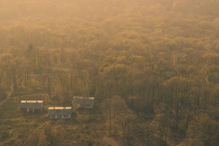 Small houses in the woods, on cold autumn dayの写真素材