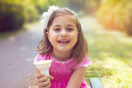 Little girl eating ice creamの写真素材