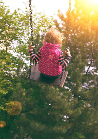 Toddler girl on the swingの写真素材