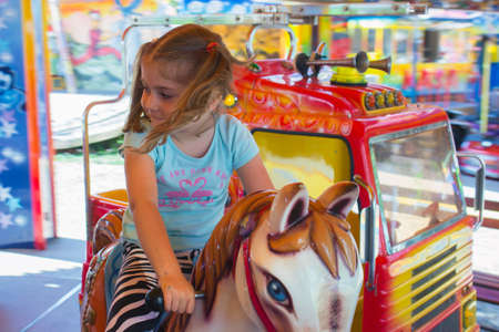 Little girl in carouselの写真素材