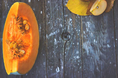 Seasonal wallpaper-pumpkin slice on dark wooden background