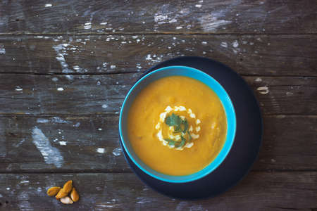 top view of pumpkin soup on wooden tableの写真素材