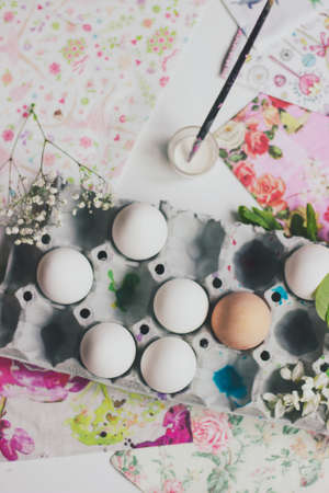 Top view of white eggs in the cardboard box, prepared for decorating; Easter background