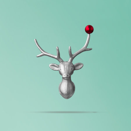 Christmas reindeer concept on teal background made of reindeer head and red bauble. Minimal winter vacation idea, new year conceptの写真素材