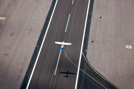 Small single engine plane taking off as viewed from aboveの写真素材