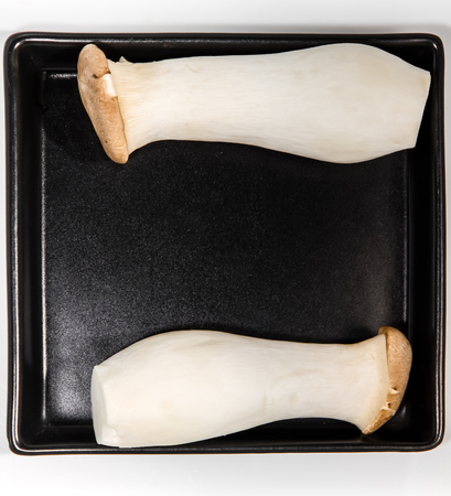 Mushroom names Eringii on a black plateの写真素材