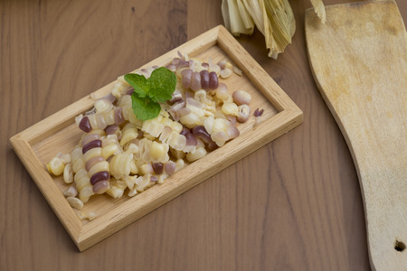 White corn on old wooden tableの写真素材