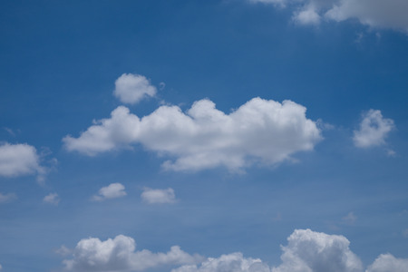 White cumulus clouds and a blue sky.の写真素材