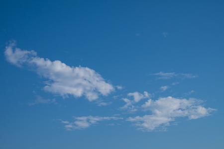 White cumulus clouds and a blue sky.の写真素材