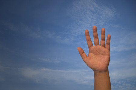 Close up of a open hand, on blue background.の写真素材