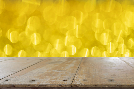 Wood table top on abstract gold bokeh, Christmas concept.の写真素材