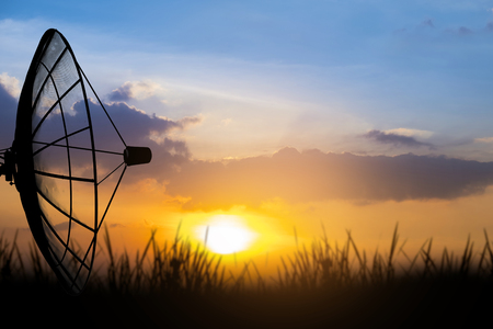 Satellite dishes. Sunset sky backgroundの写真素材