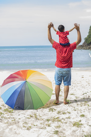 happy excited father and son playing on summer beach, enjoy lifeの写真素材