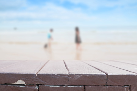 Wood table top on blur beach backgroundの写真素材