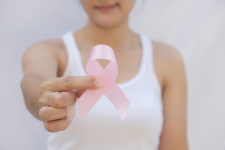 Healthcare and medicine concept. Woman hand holding pink breast cancer awareness ribbon.の写真素材