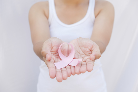 Healthcare and medicine concept. Woman hand holding pink breast cancer awareness ribbon.の写真素材