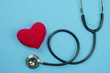 Stethoscope and Red heart on blue background. Hospital life insurance concept: World heart health day idea.の写真素材