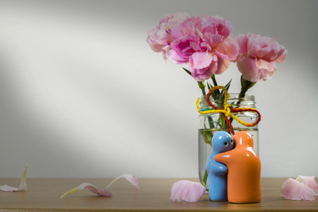 Still life with Ceramic doll and flower on wooden table over grunge background, Still life styleの写真素材
