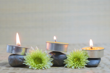 SPA concept: Spa still life with zen stones aromatic candles and flower on the matの写真素材