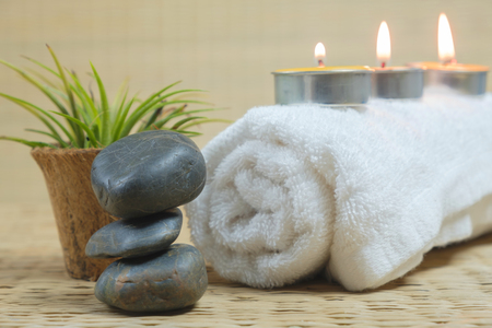 SPA concept: Spa still life with zen stones aromatic candles and flower on the matの写真素材
