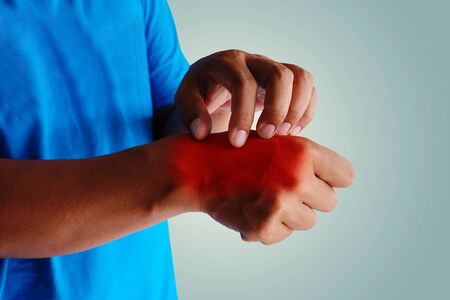 Health care concept. Itching of skin diseases in men using the hand-scratching. Red around the Itching area.の写真素材