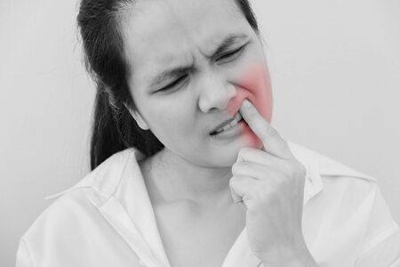 Beautiful Young Woman Suffering From Terrible Strong Teeth Pain, Touching Cheek With Hand.Tooth Pain And Dentistry.  Dental Care And Health Concept.の写真素材