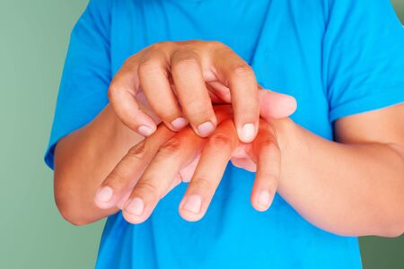 Health care concept. Itching of skin diseases in men using the hand-scratching. Red around the...