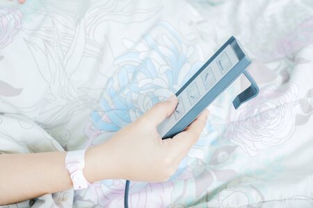 remote control to adjust the level of the hospital bed.の写真素材