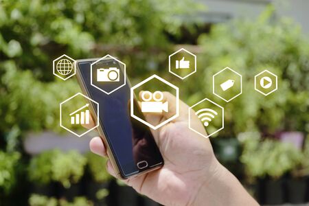 Close up of a man using mobile smartphone, social media or network on smartphone mobile, comments, likes and new followers, communication onlineの写真素材