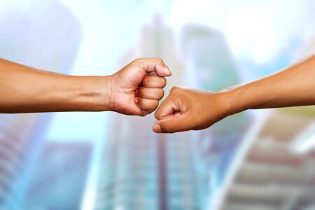 Two hands in air bumping together, Male power martial arts arms, boxing, wrestling fighter square offの写真素材
