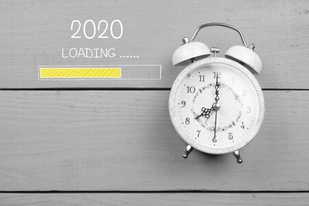 Loading concept with retro alarm clock on tableの写真素材