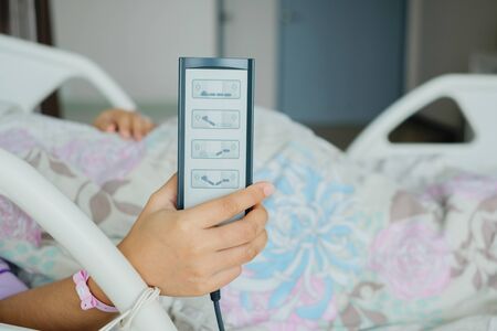 remote control to adjust the level of the hospital bed.の写真素材